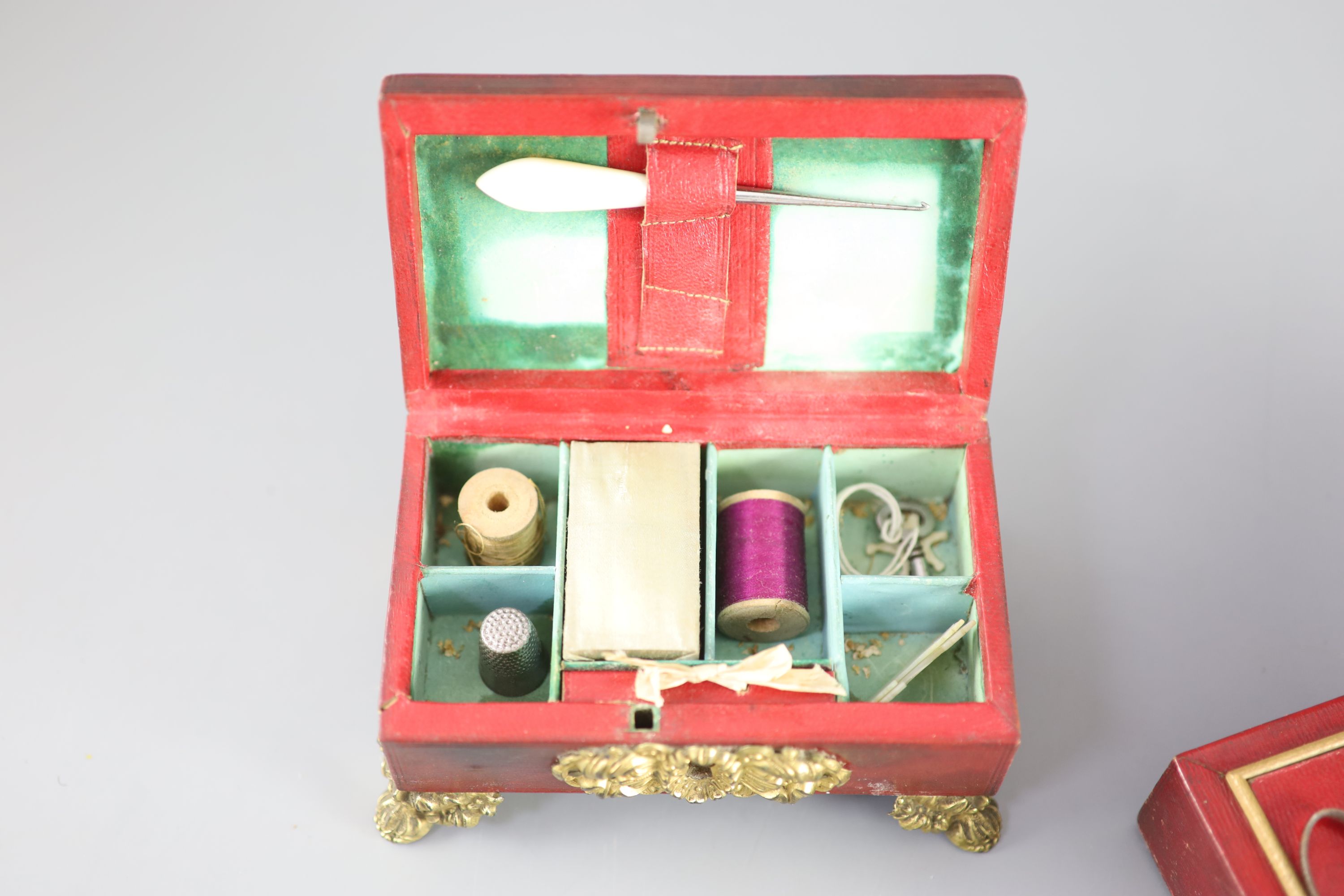 Two early 19th century red leather work boxes with assorted fittings